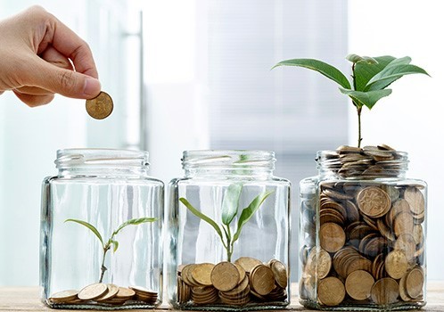 putting coin in jar